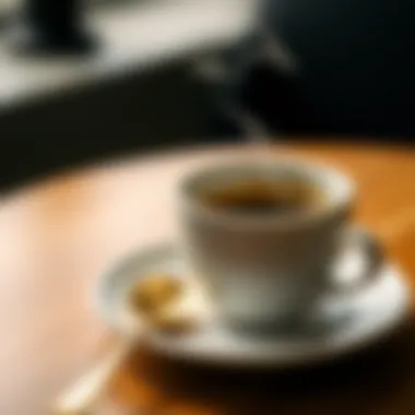 Gold espresso spoon alongside a steaming cup of coffee