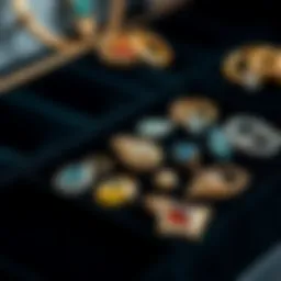 Elegant black velvet jewelry tray displaying an assortment of gemstones and precious metals.