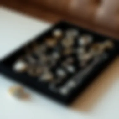 A collection of vintage and modern jewelry pieces artistically arranged on a black velvet tray.