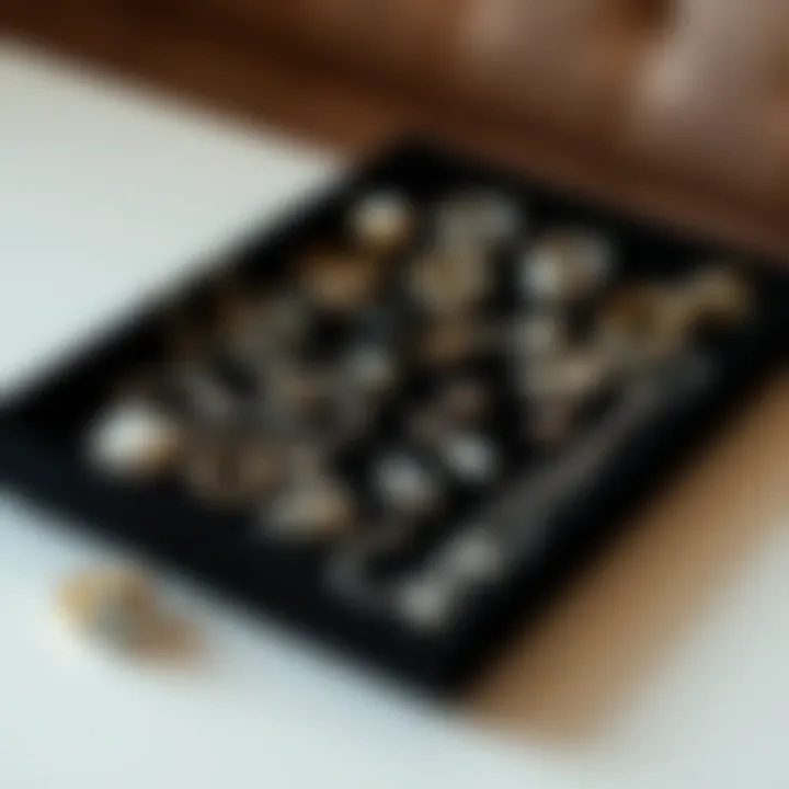 A collection of vintage and modern jewelry pieces artistically arranged on a black velvet tray.