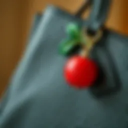 Elegant cherry bag charm displayed on a handbag