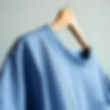 A stylish crew neck scrub top on a hanger showcasing fabric texture