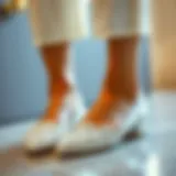 A stylish pair of fancy white flats with intricate detailing