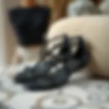 Elegant black beaded flat sandals displayed on a stylish surface