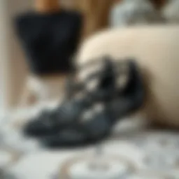 Elegant black beaded flat sandals displayed on a stylish surface